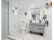 Modern bathroom with walk-in shower, neutral tile, floating vanity, and updated lighting at 3942 Alcott St, Denver, CO 80211
