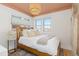 Cozy bedroom with warm tones, two windows and a woven light fixture at 3942 Alcott St, Denver, CO 80211