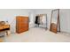 Bedroom area featuring neutral carpet, light walls, closet space, a dresser, and a large mirror at 3942 Alcott St, Denver, CO 80211