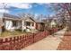 Charming home featuring solar panels and a cozy front porch, nestled behind a picket fence at 3942 Alcott St, Denver, CO 80211
