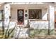 Inviting white brick front porch with painted steps, large window, and decorative door at 3942 Alcott St, Denver, CO 80211