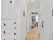 Bright hallway features hardwood floors and access to a bedroom with built-in shelving at 3942 Alcott St, Denver, CO 80211