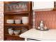 Close-up of a kitchen counter, showcasing dishes, decor, white countertops, and colorful backsplash at 3942 Alcott St, Denver, CO 80211