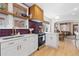 Well-lit kitchen with stainless steel appliances, white cabinets, wood accents, and an island counter at 3942 Alcott St, Denver, CO 80211