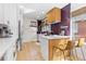 Stylish kitchen with white cabinets, hardwood floors, stainless steel appliances, and butcher-block countertop at 3942 Alcott St, Denver, CO 80211