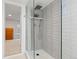 Walk-in shower featuring neutral tile, modern fixtures, and glass enclosure with bathroom access at 3942 Alcott St, Denver, CO 80211