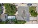 Birds-eye view of a home with an ashpalt shingle roof, mature trees, and a fenced yard at 6871 Locust St, Commerce City, CO 80022