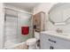 Modern bathroom with a glass-enclosed shower, gray vanity, and stylish fixtures at 6871 Locust St, Commerce City, CO 80022