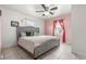 Cozy bedroom with neutral tile floors and a large, tufted headboard at 6871 Locust St, Commerce City, CO 80022