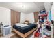 Bedroom with tile flooring, a bed with a black bedspread and lots of storage space at 6871 Locust St, Commerce City, CO 80022