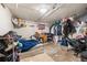 Bedroom featuring stained concrete floors, a bed, closet and a black office chair at 6871 Locust St, Commerce City, CO 80022