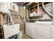 Laundry room featuring a utility sink, washing machine, and dryer at 6871 Locust St, Commerce City, CO 80022