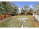 Fenced backyard with patchy grass and some snow at 12569 W Crestline Dr, Littleton, CO 80127