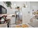 Bright kitchen with stainless steel refrigerator and ample cabinet space at 12569 W Crestline Dr, Littleton, CO 80127