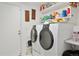 Laundry room with washer, dryer, and ample shelving at 12569 W Crestline Dr, Littleton, CO 80127