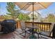 Outdoor deck with patio furniture, grill, and views of backyard and foliage at 7665 S Steele St, Centennial, CO 80122