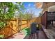 Small patio with an AC Unit, garden area, new turf and a wood fence at 7665 S Steele St, Centennial, CO 80122