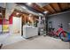 The unfinished basement features a laundry area, utilities, and space for storage or hobbies at 7665 S Steele St, Centennial, CO 80122