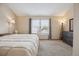 Bedroom with carpet, large windows with blinds, and a floor mirror at 7665 S Steele St, Centennial, CO 80122