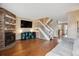 Bright living room with hardwood floors, fireplace, and staircase to the second floor at 7665 S Steele St, Centennial, CO 80122