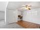 Finished basement with wood-look flooring, ceiling fan, white walls, closet, and natural light from window with plantation shutters at 12065 E Kentucky Ave, Aurora, CO 80012