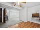Finished basement with stairs, gray carpet, wood-look flooring, ceiling fan, white walls, and bright natural light at 12065 E Kentucky Ave, Aurora, CO 80012
