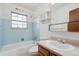 Light blue bathroom with a tub, shower, and vanity at 12065 E Kentucky Ave, Aurora, CO 80012