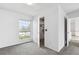 Well-lit bedroom with carpet and a view of the outside at 12065 E Kentucky Ave, Aurora, CO 80012
