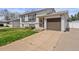 Charming two-story home with a well-maintained lawn, an attached garage, and inviting curb appeal at 12065 E Kentucky Ave, Aurora, CO 80012