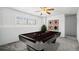 Basement game room with a vintage style billiard table, neutral paint, and a large window at 12065 E Kentucky Ave, Aurora, CO 80012