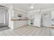 Well-lit kitchen showcasing white cabinets, tile flooring, and essential appliances at 12065 E Kentucky Ave, Aurora, CO 80012
