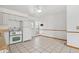 Eat-in kitchen featuring tile floors, white cabinets, and a view of the backyard through the window at 12065 E Kentucky Ave, Aurora, CO 80012
