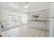 Bright kitchen with white cabinets, tiled floor, and modern appliances at 12065 E Kentucky Ave, Aurora, CO 80012