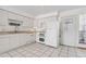 Bright kitchen featuring classic cabinets, updated appliances, and abundant natural light at 12065 E Kentucky Ave, Aurora, CO 80012