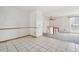 Open-concept living room featuring tiled floor and a connecting carpeted space at 12065 E Kentucky Ave, Aurora, CO 80012