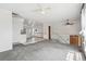 Bright living room with neutral paint and carpet, and modern lighting, that provides plenty of sunlight at 12065 E Kentucky Ave, Aurora, CO 80012
