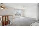 Spacious living room with carpet, ceiling fan and large window providing ample natural light at 12065 E Kentucky Ave, Aurora, CO 80012