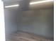 Bright walk-in closet with gray walls and wood-look flooring; illuminated with overhead lighting at 12065 E Kentucky Ave, Aurora, CO 80012