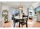 Cozy dining room features wood floors, pendant lighting, and backyard access, perfect for intimate meals at 12420 E Iliff Pl, Aurora, CO 80014