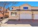 Front exterior view of home with stucco siding, arch feature over the garage and front walkway at 12420 E Iliff Pl, Aurora, CO 80014
