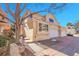 Charming exterior featuring stucco siding, attached garage, and manicured front yard, complemented by a mature tree at 12420 E Iliff Pl, Aurora, CO 80014