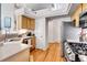 Bright kitchen with wooden cabinets, stainless steel appliances, hardwood floors, and an open layout at 12420 E Iliff Pl, Aurora, CO 80014