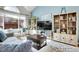 Cozy living room area with plush seating, a large window, and stylish decor, including a wooden bookshelf at 12420 E Iliff Pl, Aurora, CO 80014