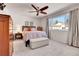 Serene main bedroom with a ceiling fan, ample natural light, and neutral decor at 12420 E Iliff Pl, Aurora, CO 80014