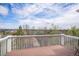 This back deck has wooden floors, white banisters, and a beautiful landscape view at 2749 Pemberly Ave, Highlands Ranch, CO 80126