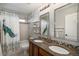 Bathroom featuring a double sink vanity, shower-tub combination, and elegant decor at 2749 Pemberly Ave, Highlands Ranch, CO 80126