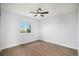 This bedroom boasts hardwood floors, neutral paint, and a decorative ceiling fan at 2749 Pemberly Ave, Highlands Ranch, CO 80126