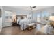 This bedroom offers natural light, wood flooring, and a ceiling fan for optimal comfort at 2749 Pemberly Ave, Highlands Ranch, CO 80126