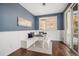 Cozy dining area features built-in bench seating, wainscoting, a contemporary light fixture, and sliding glass doors at 2749 Pemberly Ave, Highlands Ranch, CO 80126