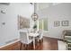 Bright dining area with hardwood floors, stylish chandelier, and large windows providing plenty of natural light at 2749 Pemberly Ave, Highlands Ranch, CO 80126